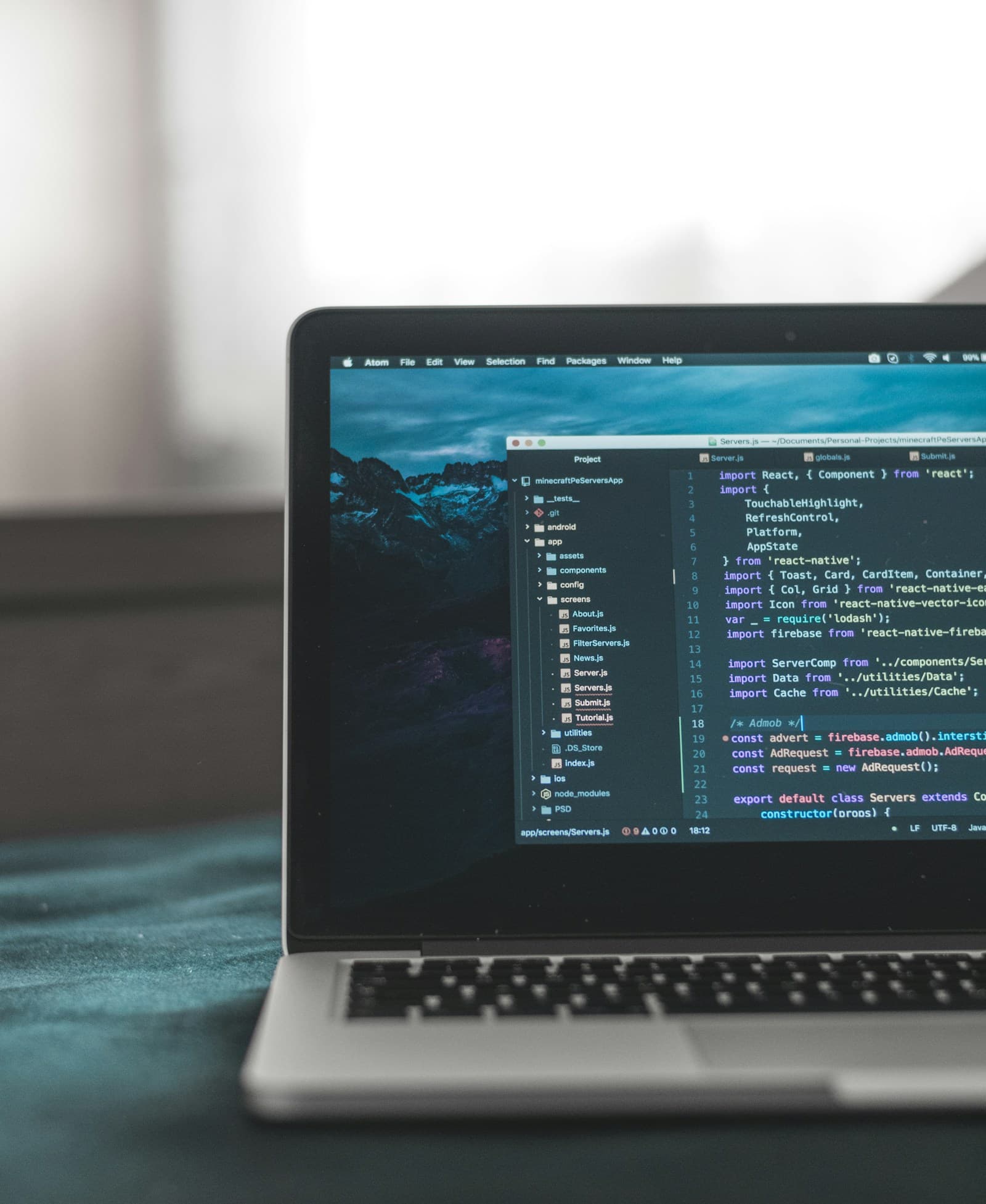 A development workspace with code open on a laptop